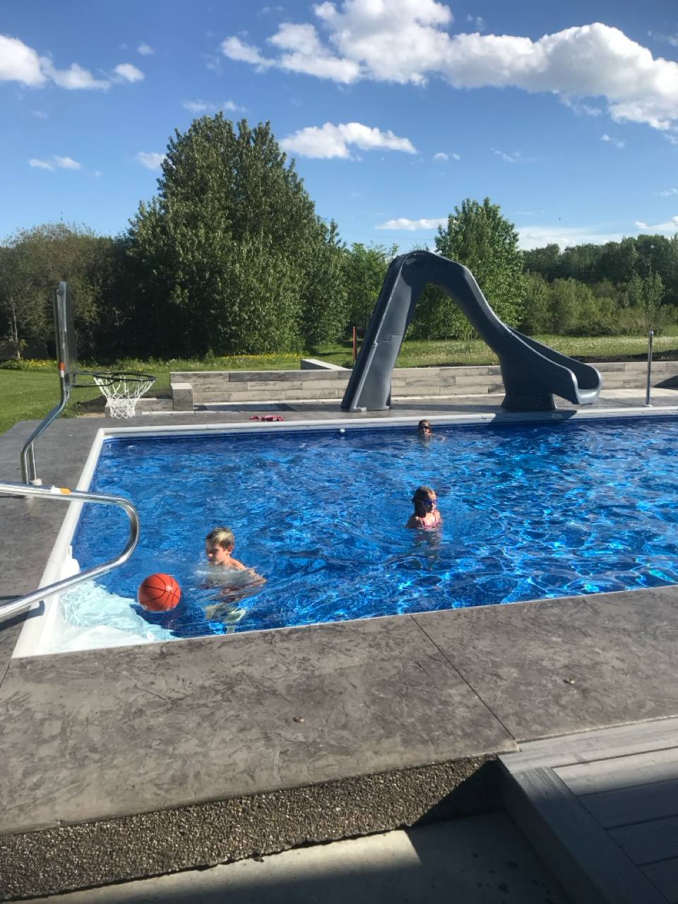 Kids playing in the pool during the day